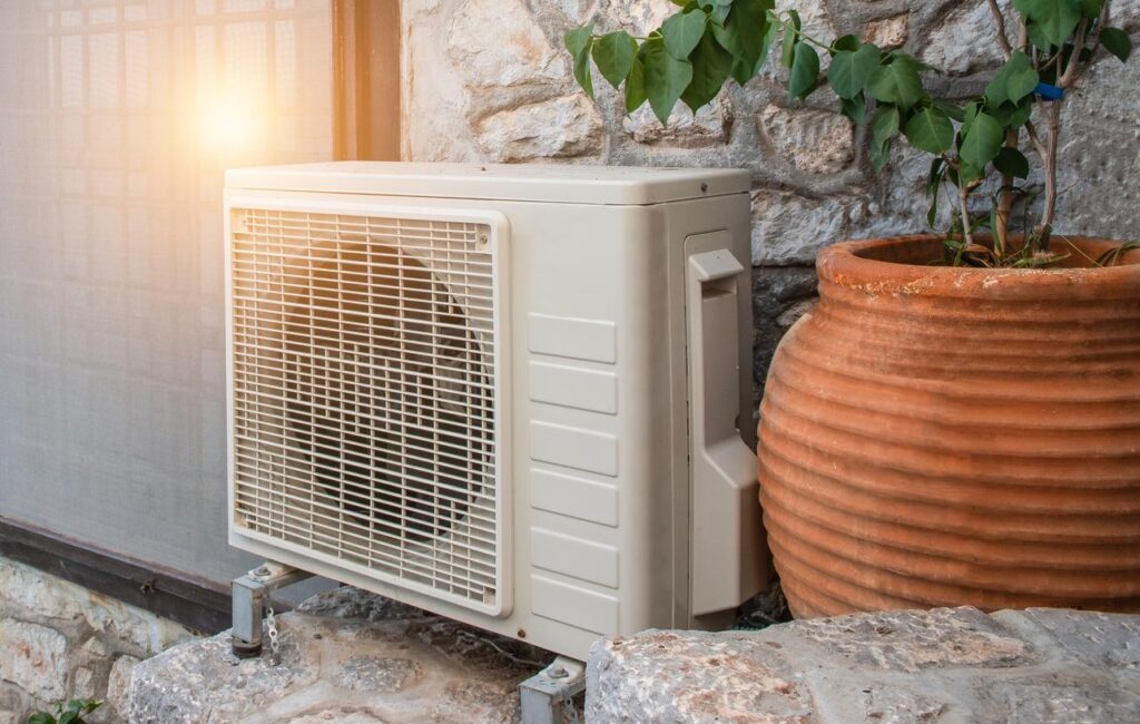 Heat pump unit sits outside of stone residence