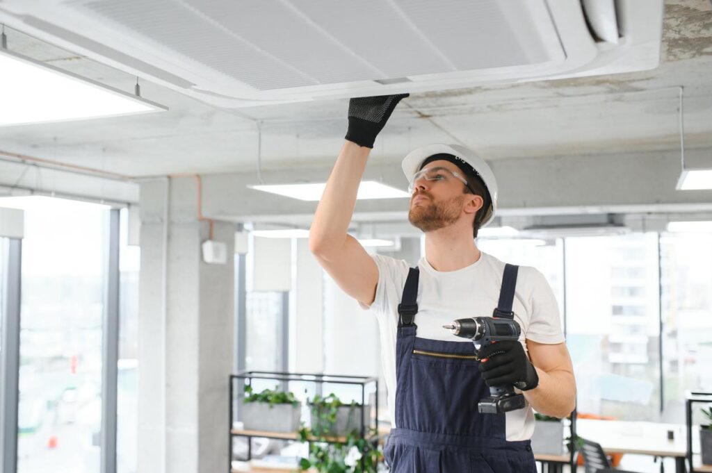 A male HVAC technician repairing an air conditioner.