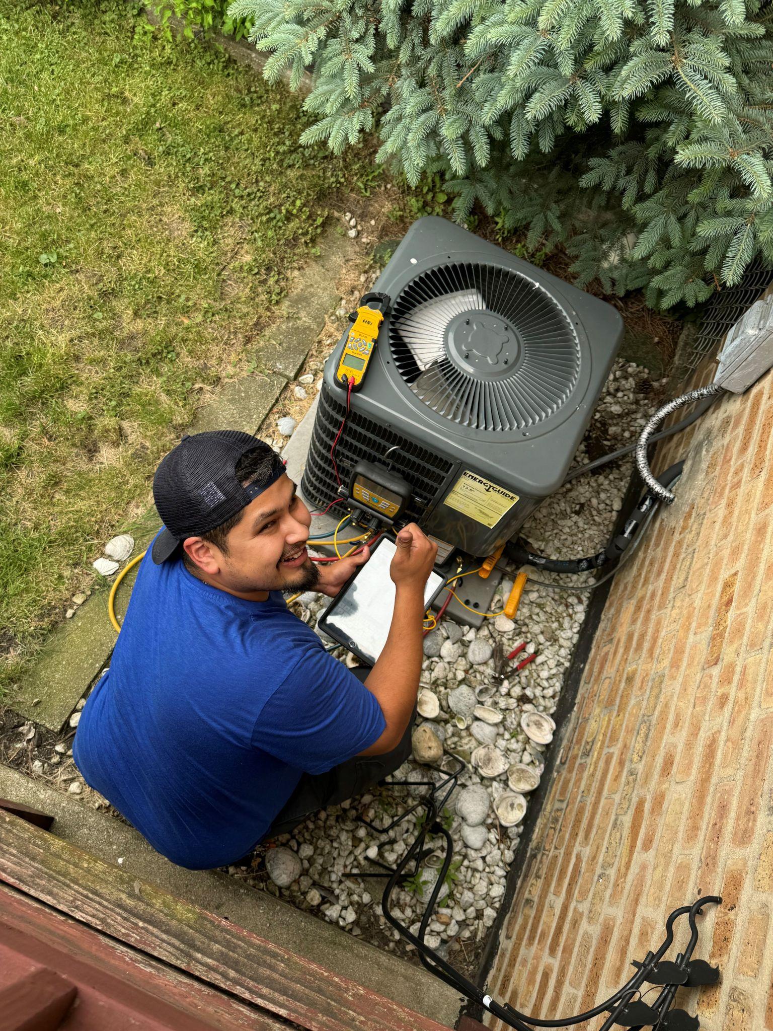 Deljo tech performing an HVAC tune-up