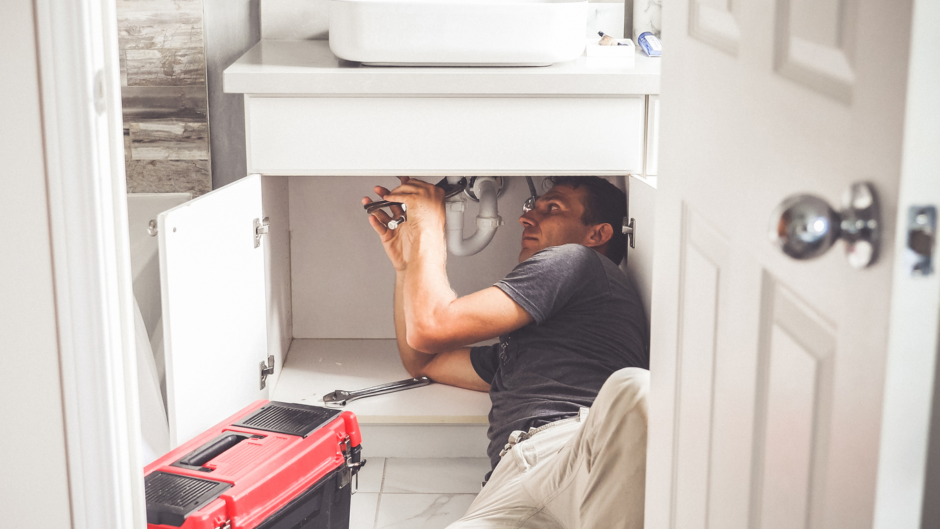 Plumber Man With Tools In the bathroom.